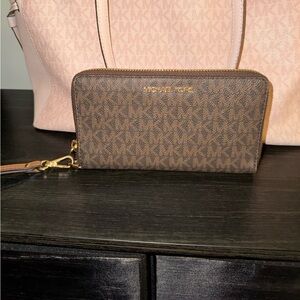 Michael kors wristlet in signature brown and acorn color.
